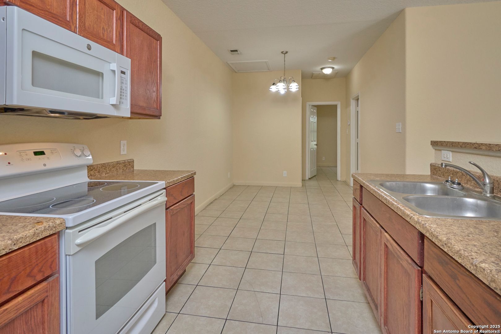 10911 Baltic Drive, Unit 102 San Antonio, TX 78213 - Photo 11 of 23 a kitchen with a sink and a stove top oven