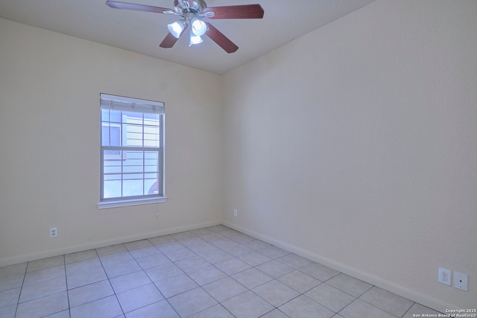 10911 Baltic Drive, Unit 102 San Antonio, TX 78213 - Photo 13 of 23 an empty room with chandelier fan and windows