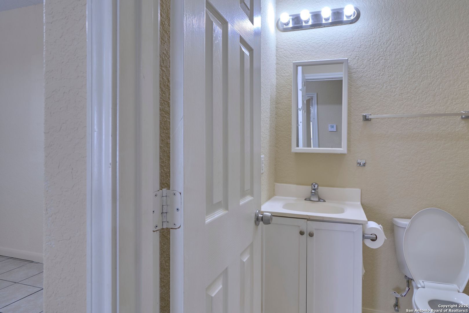 10911 Baltic Drive, Unit 102 San Antonio, TX 78213 - Photo 16 of 23 a bathroom with a sink mirror and toilet