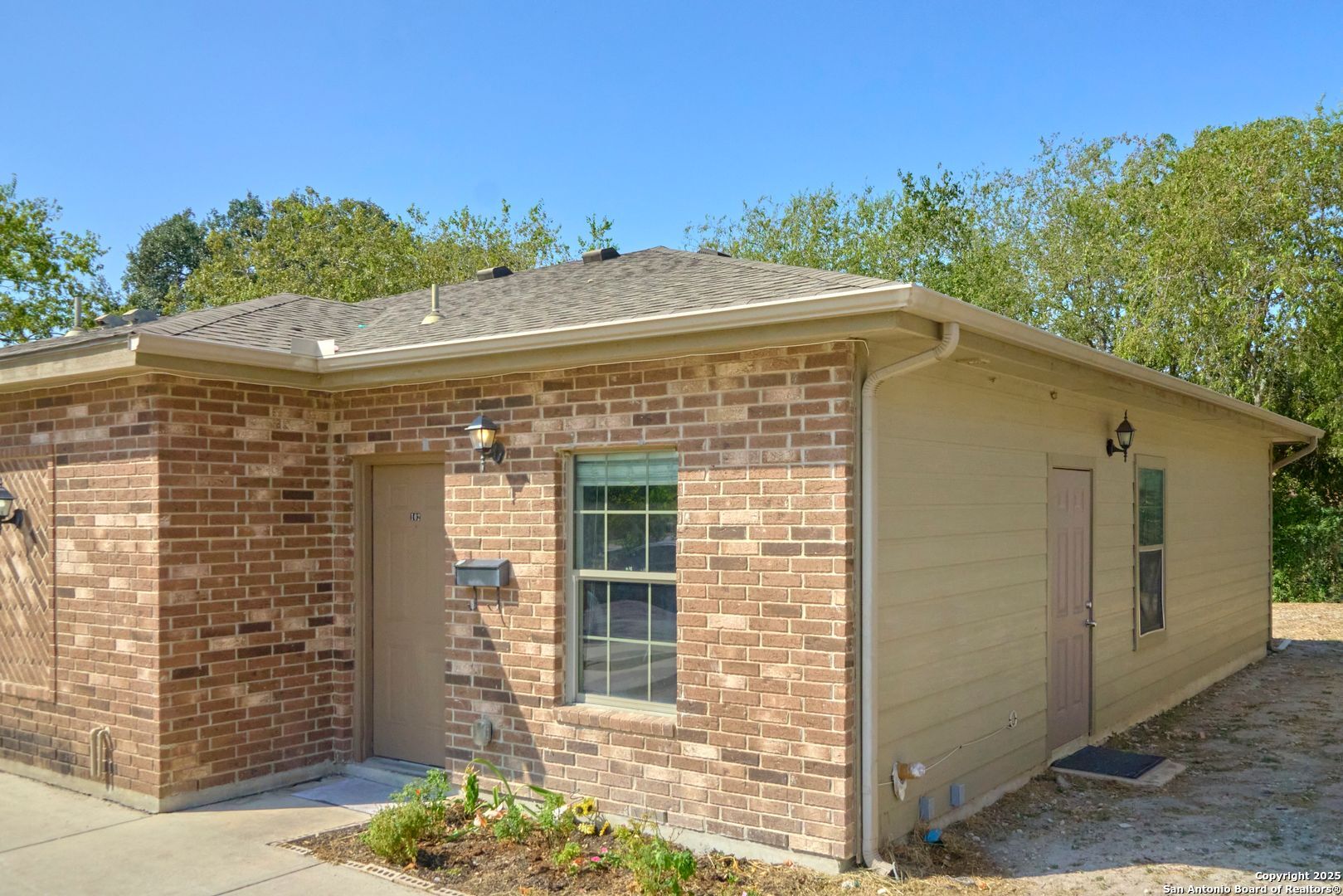 10911 Baltic Drive, Unit 102 San Antonio, TX 78213 - Photo 2 of 23 a front view of a house with a yard