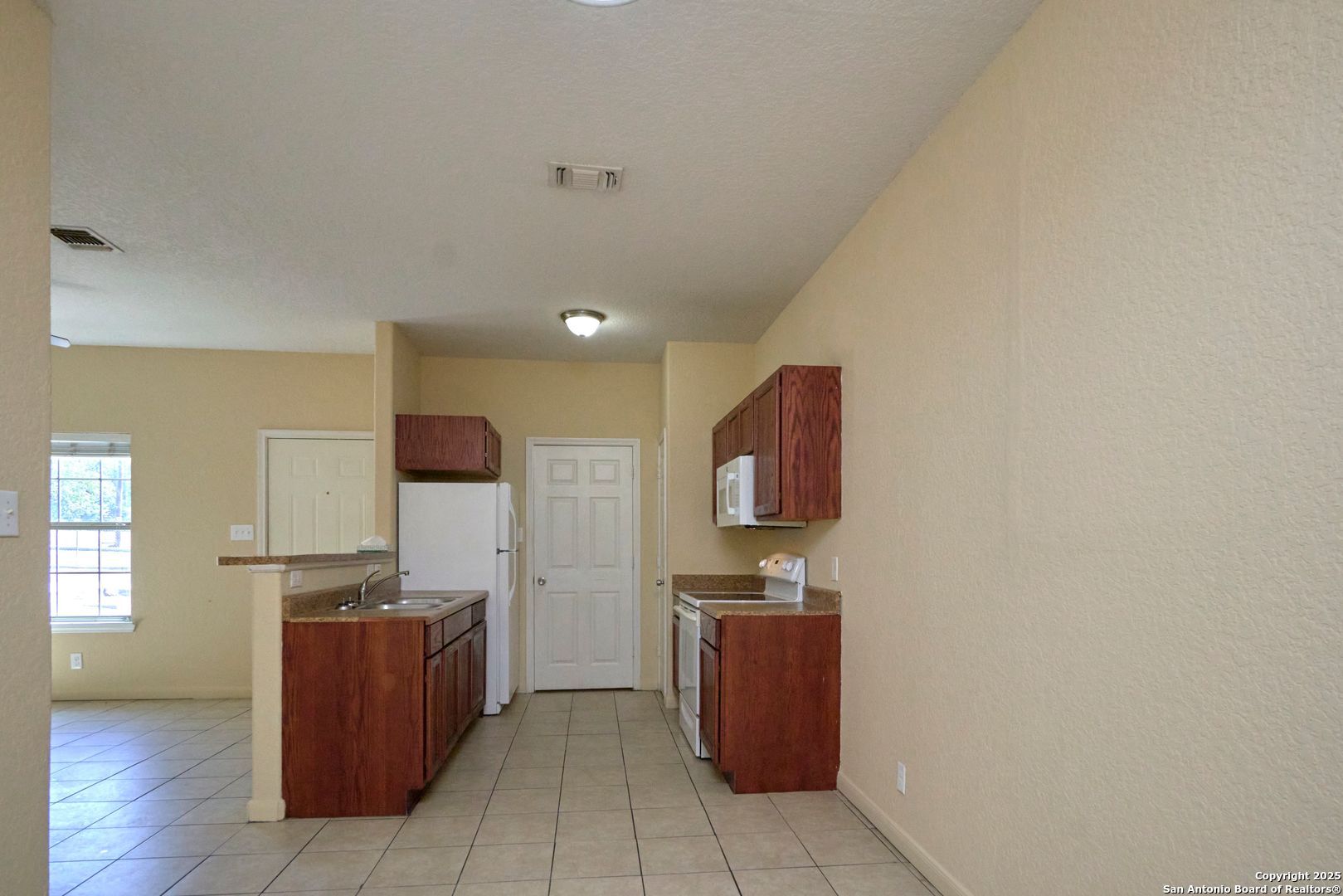 10911 Baltic Drive, Unit 102 San Antonio, TX 78213 - Photo 7 of 23 a room with furniture a flat screen tv and kitchen view