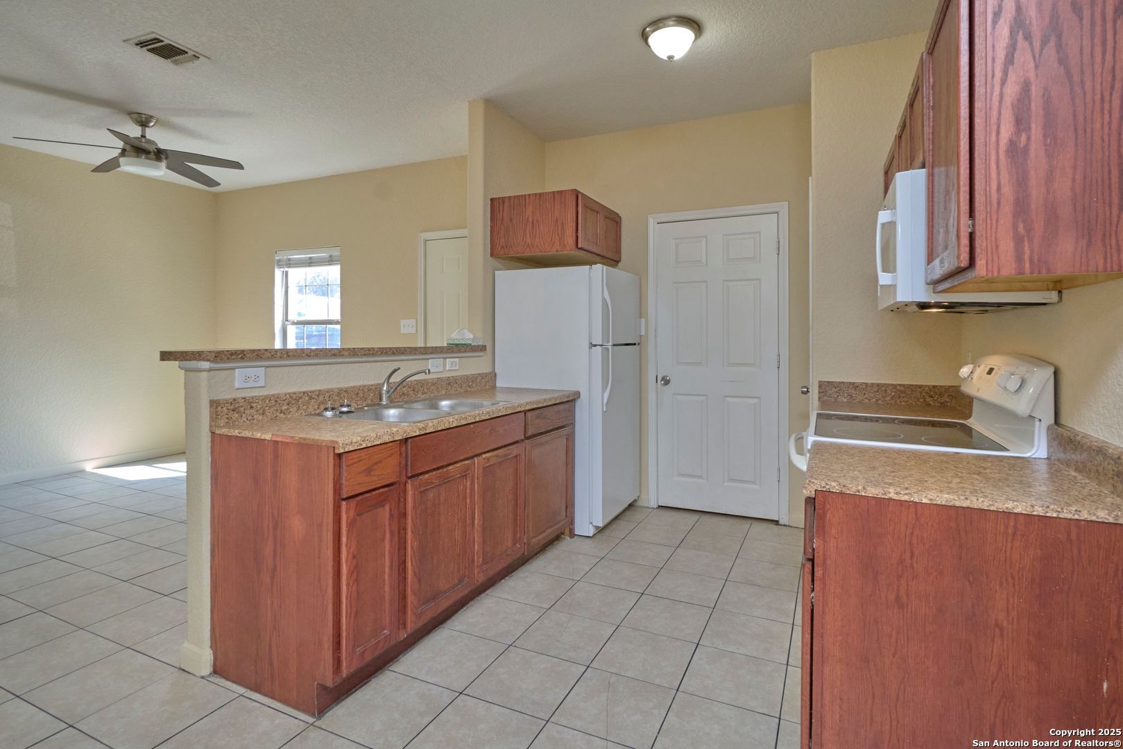 10911 Baltic Drive, Unit 102 San Antonio, TX 78213 - Photo 10 of 23 a kitchen with stainless steel appliances granite countertop a sink stove and refrigerator