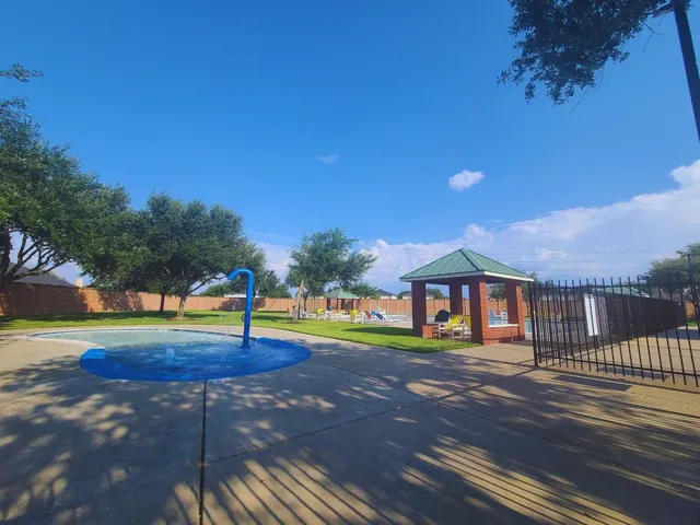 a view of a swimming pool with an outdoor space and seating area