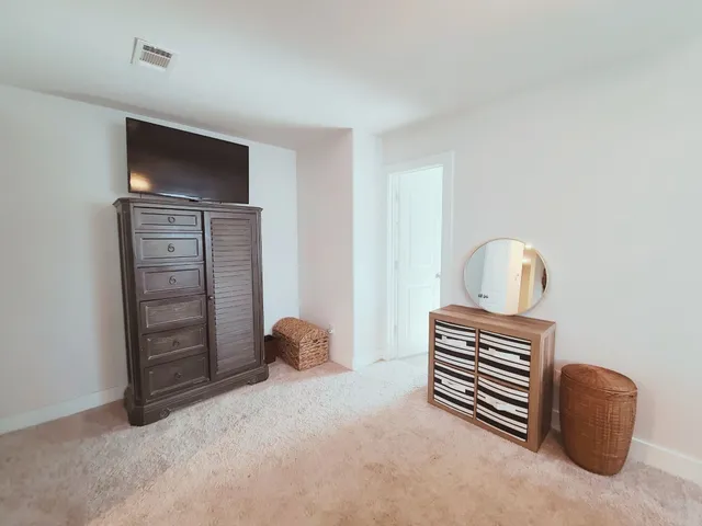 a bedroom with a bed and a television