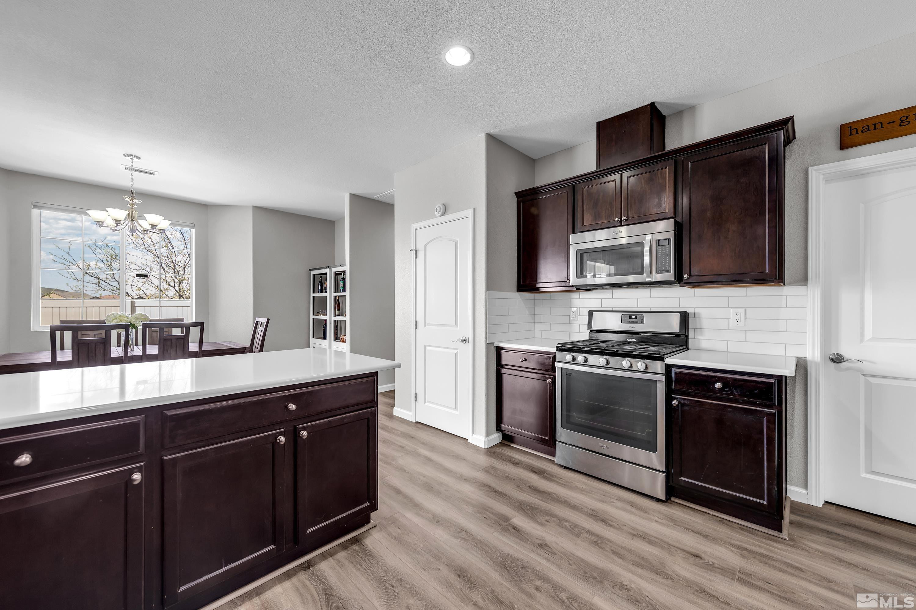 2255 Makenna Drive Reno, NV 89521 - Photo 11 of 34 a kitchen with stainless steel appliances granite countertop a stove a sink and a microwave