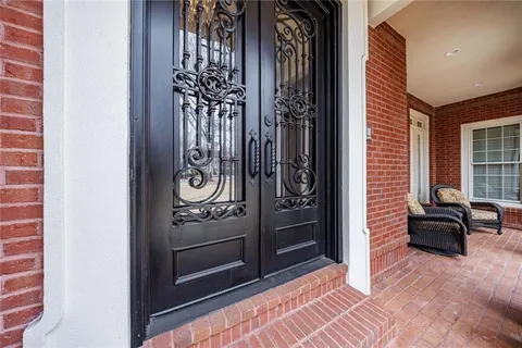 a living room with fireplace furniture and a rug