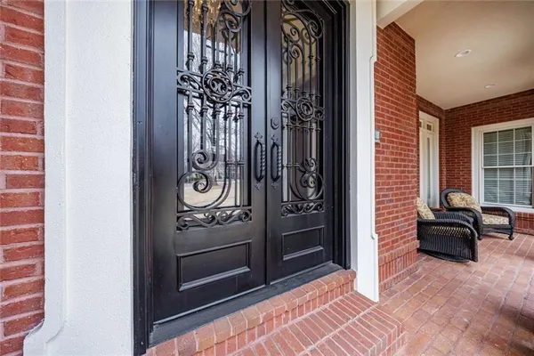 a living room with fireplace furniture and a rug
