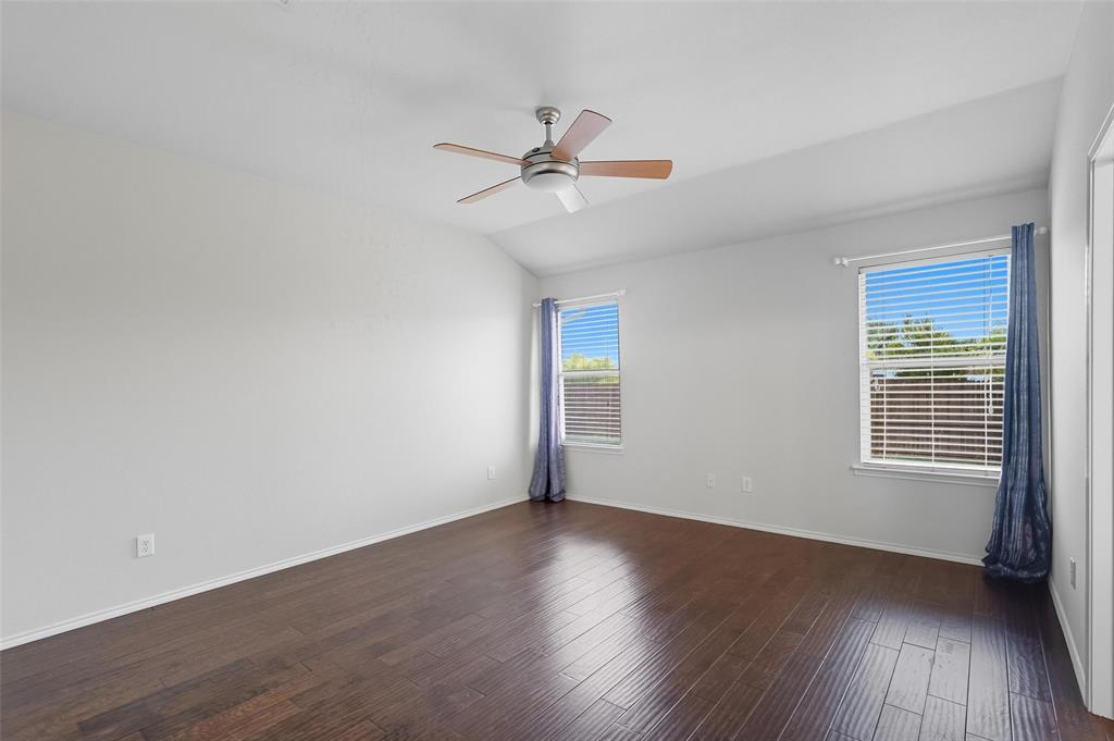 9822 Revolution Way Frisco, TX 75033 - Photo 10 of 29 a view of an empty room with wooden floor and a window