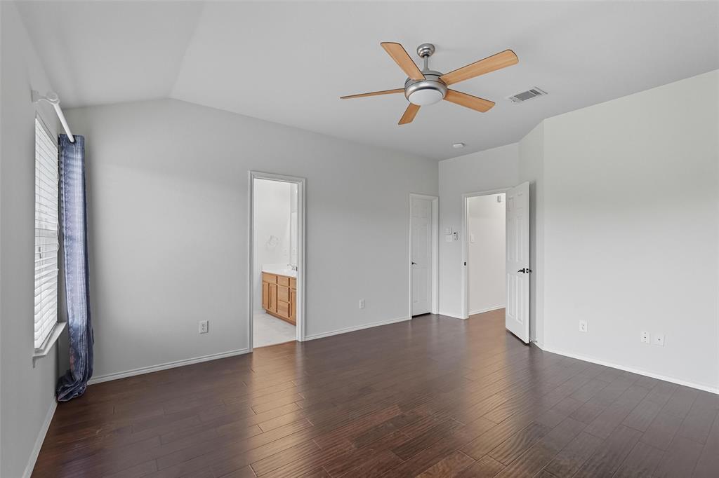 9822 Revolution Way Frisco, TX 75033 - Photo 12 of 29 an empty room with wooden floor a ceiling fan and a window