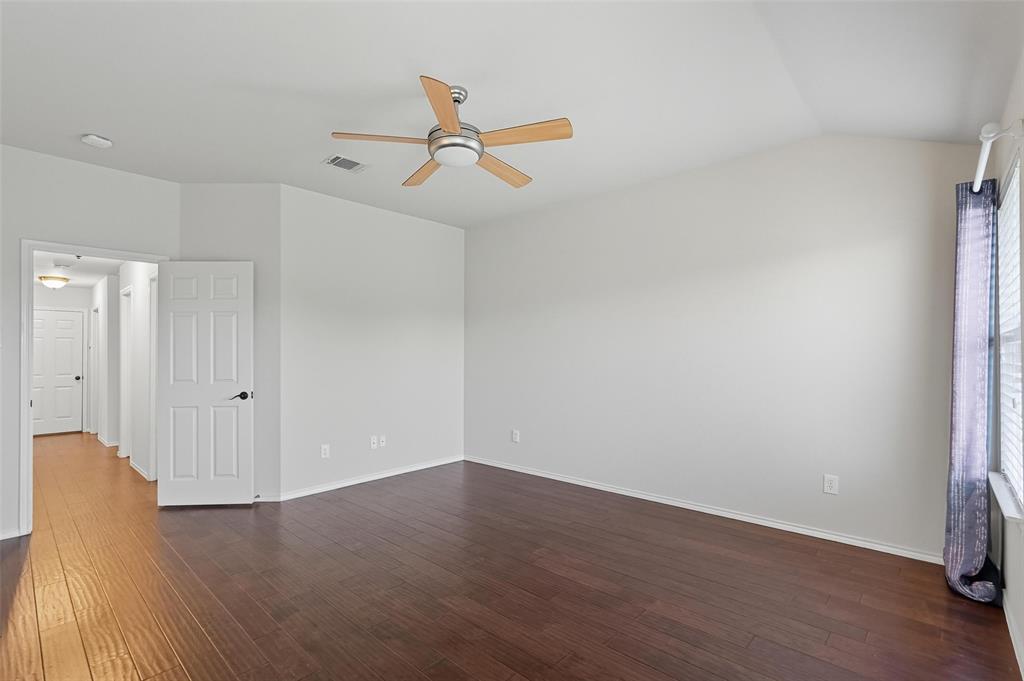 9822 Revolution Way Frisco, TX 75033 - Photo 13 of 29 an empty room with wooden floor and windows