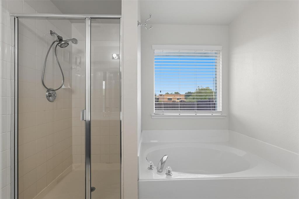 9822 Revolution Way Frisco, TX 75033 - Photo 14 of 29 a bathroom with a bath tub and a shower