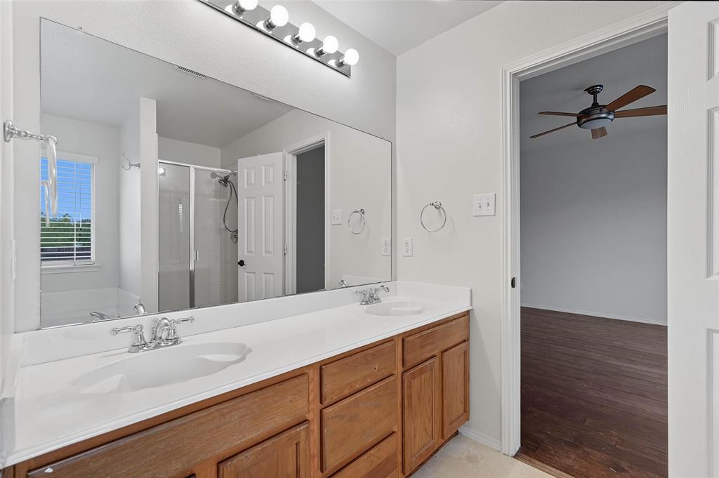 9822 Revolution Way Frisco, TX 75033 - Photo 15 of 29 a bathroom with a double vanity sink and mirror
