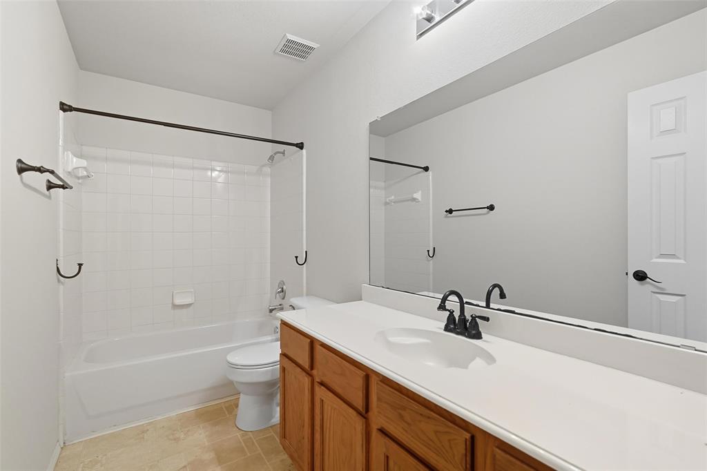 9822 Revolution Way Frisco, TX 75033 - Photo 17 of 29 a bathroom with a sink a toilet and shower