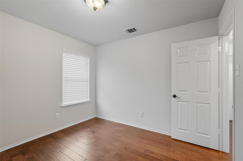 9822 Revolution Way Frisco, TX 75033 - Photo 19 of 29 an empty room with wooden floor and windows