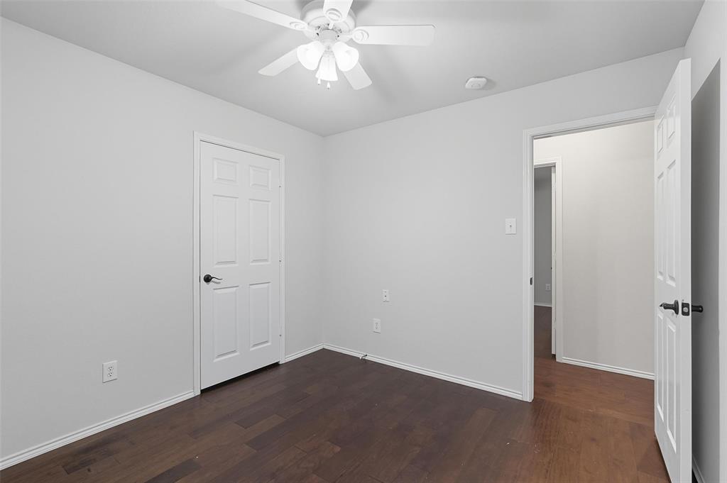 9822 Revolution Way Frisco, TX 75033 - Photo 23 of 29 an empty room with wooden floor closet and fan