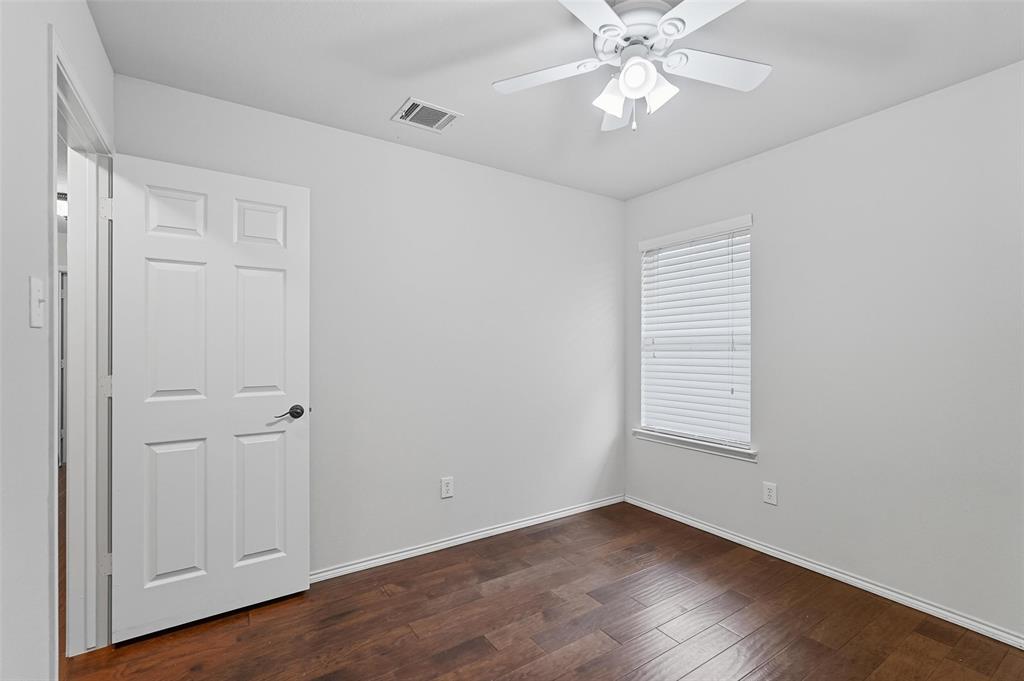 9822 Revolution Way Frisco, TX 75033 - Photo 25 of 29 an empty room with wooden floor closet and windows