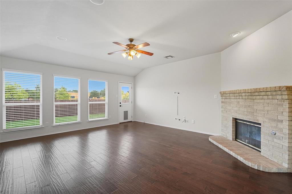 9822 Revolution Way Frisco, TX 75033 - Photo 4 of 29 a view of empty room with wooden floor and fireplace