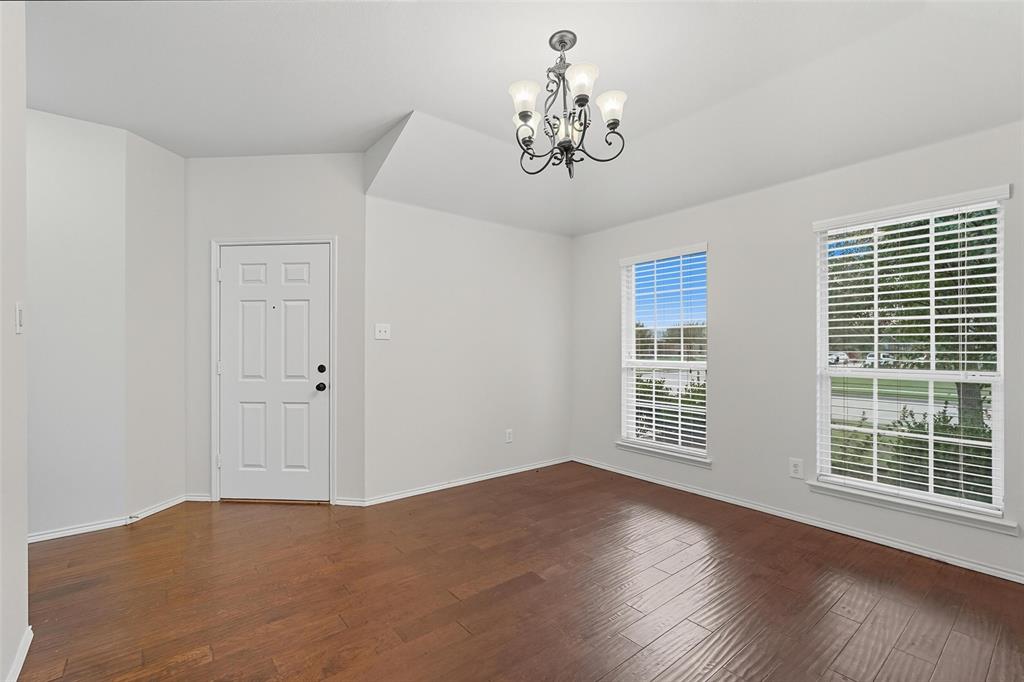 9822 Revolution Way Frisco, TX 75033 - Photo 9 of 29 a view of an empty room with a window and wooden floor
