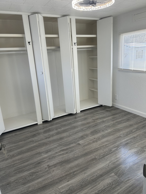 1237 Central Street, Unit 15 Leominster, MA 01453 - Photo 21 of 25 a view of an empty room with wooden floor and a window