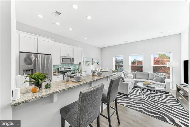 a large kitchen with a table and chairs