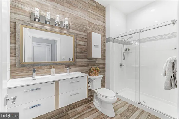a bathroom with a sink a toilet and shower