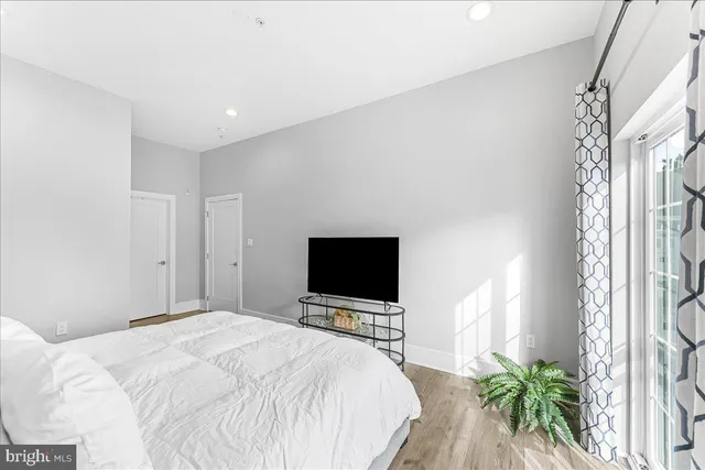 a bedroom with a bed and a flat screen tv