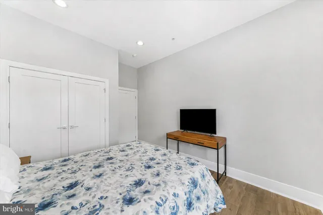 a bedroom with a bed and a flat screen tv