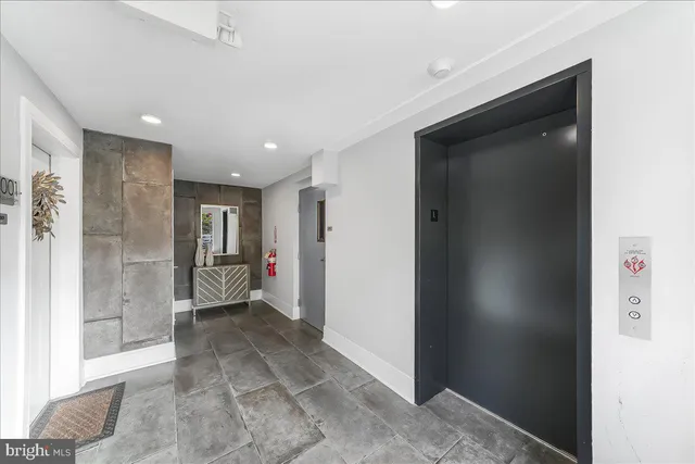 a view of a hallway with bathroom