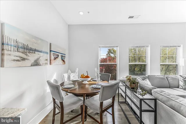 a view of a dining room with furniture and a window