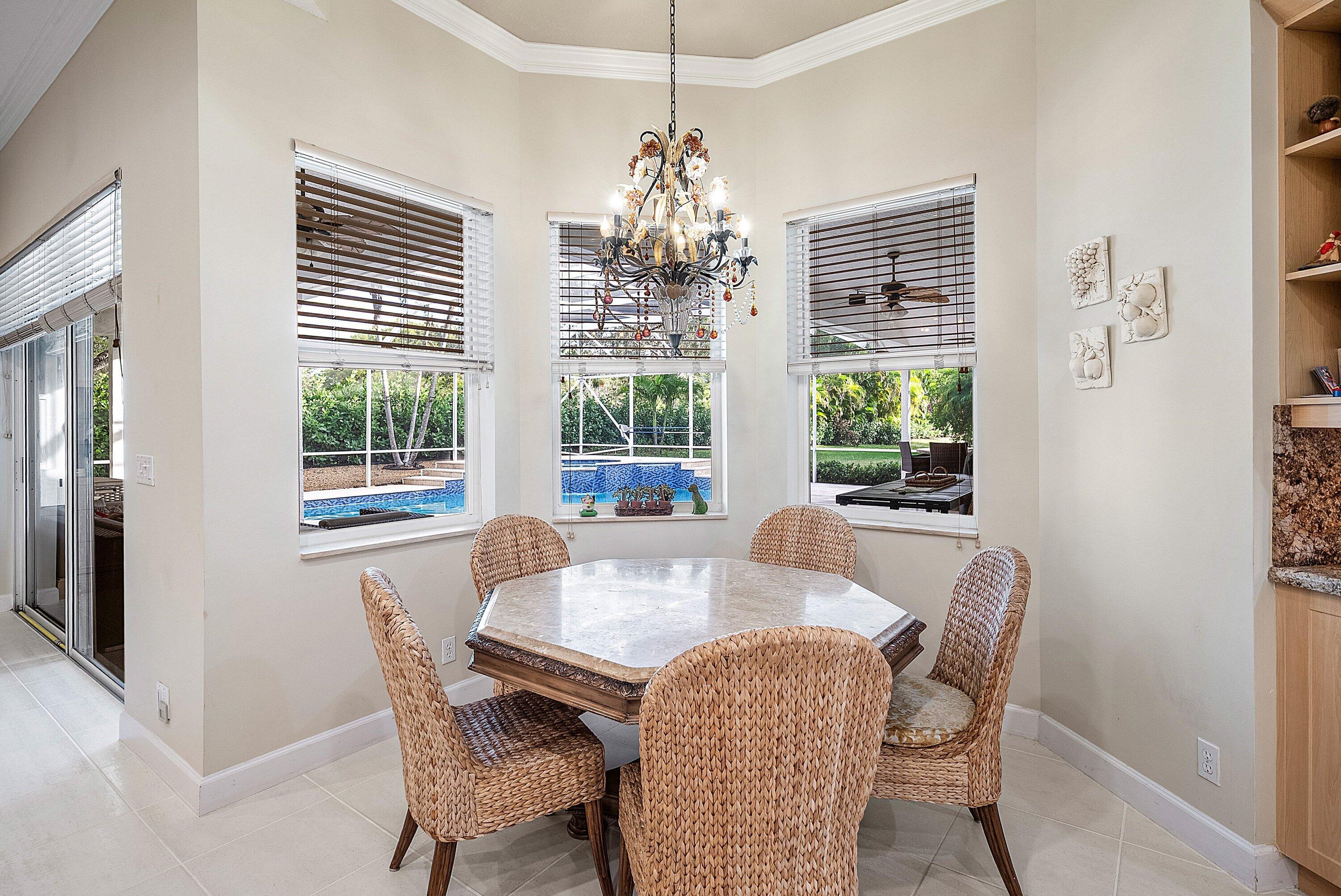 21374 Falls Ridge Way Boca Raton, FL 33428 - Photo 16 of 69 a dining room with furniture a chandelier and window