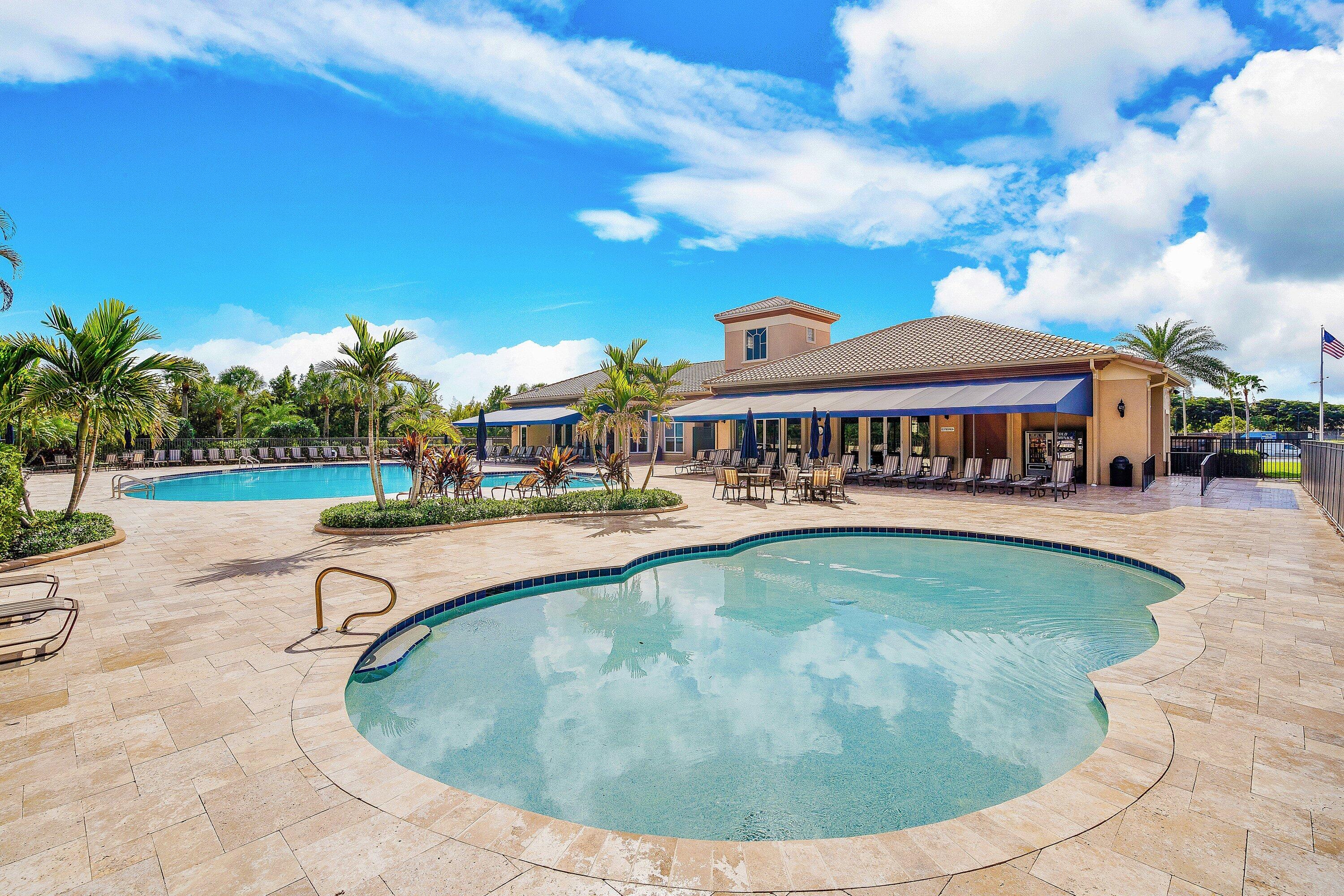 21374 Falls Ridge Way Boca Raton, FL 33428 - Photo 55 of 69 a view of swimming pool that has lawn chairs with plants and palm trees