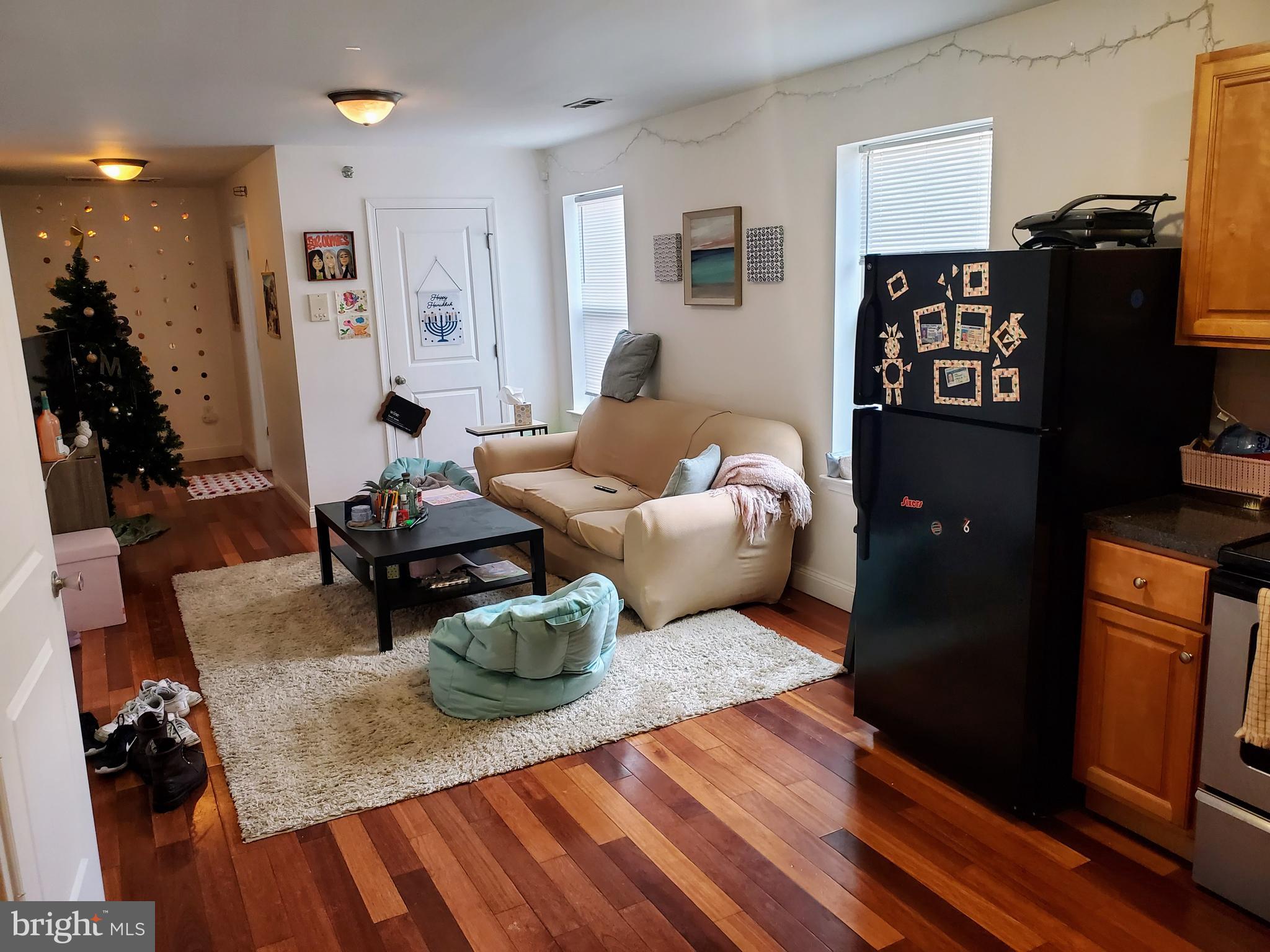 1525 North 17th Street, Unit 3 Philadelphia, PA 19121 - Photo 2 of 10 a living room with furniture and wooden floor