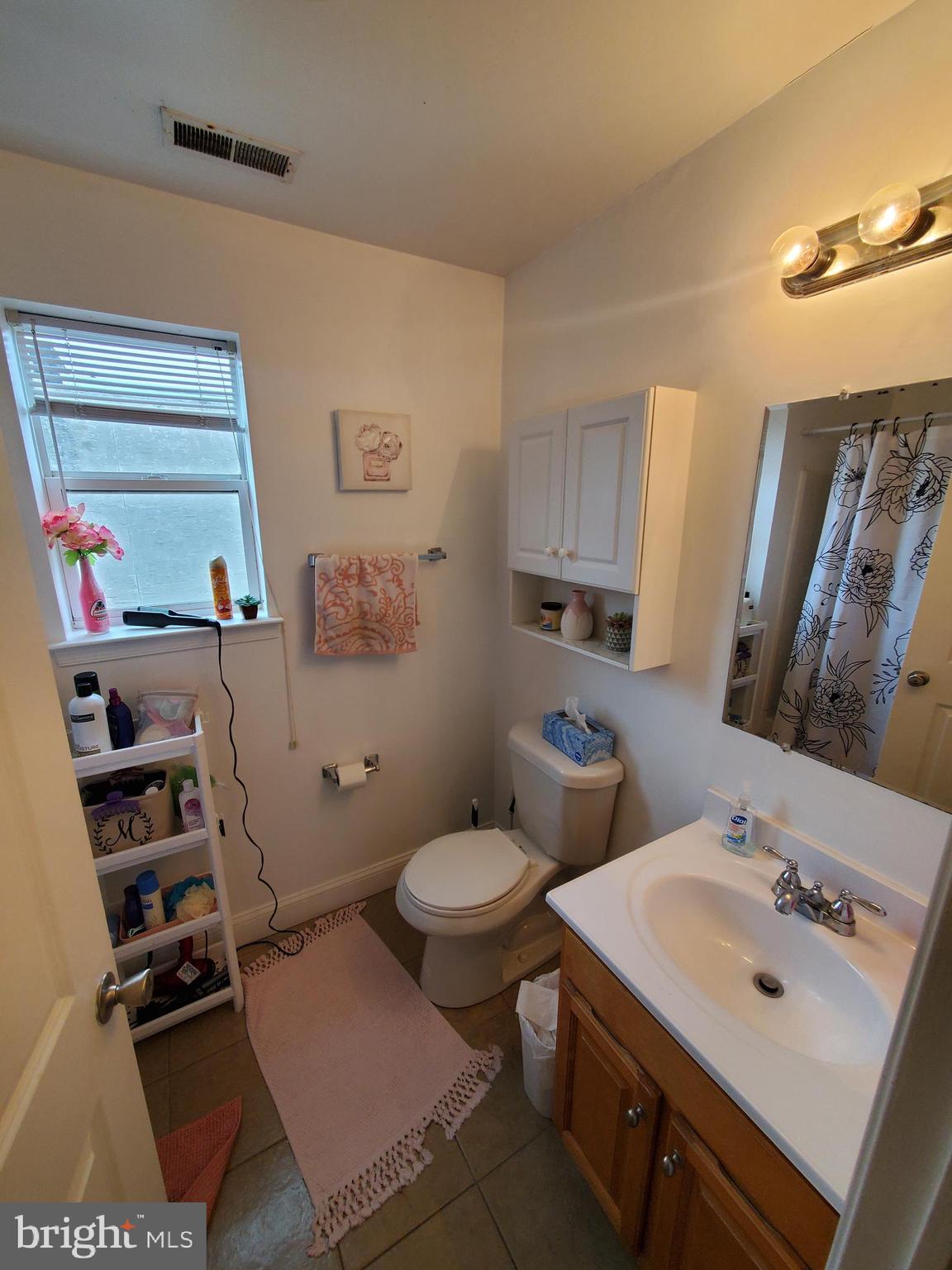 1525 North 17th Street, Unit 3 Philadelphia, PA 19121 - Photo 6 of 10 a bathroom with a sink toilet and a mirror