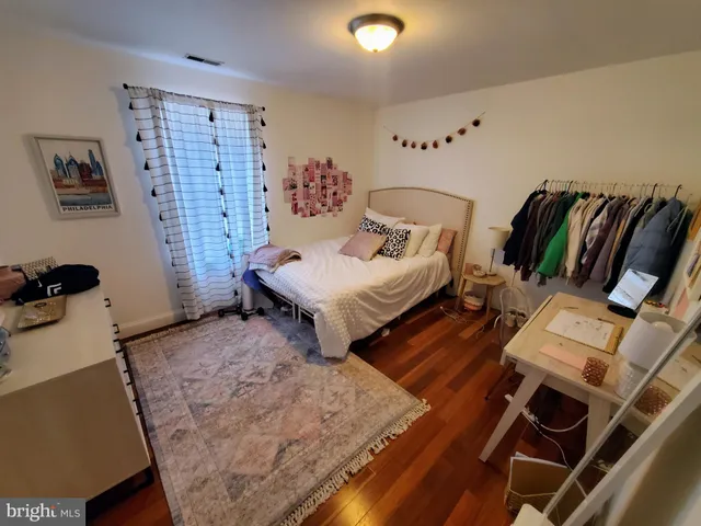 a bedroom with furniture and a wooden floor