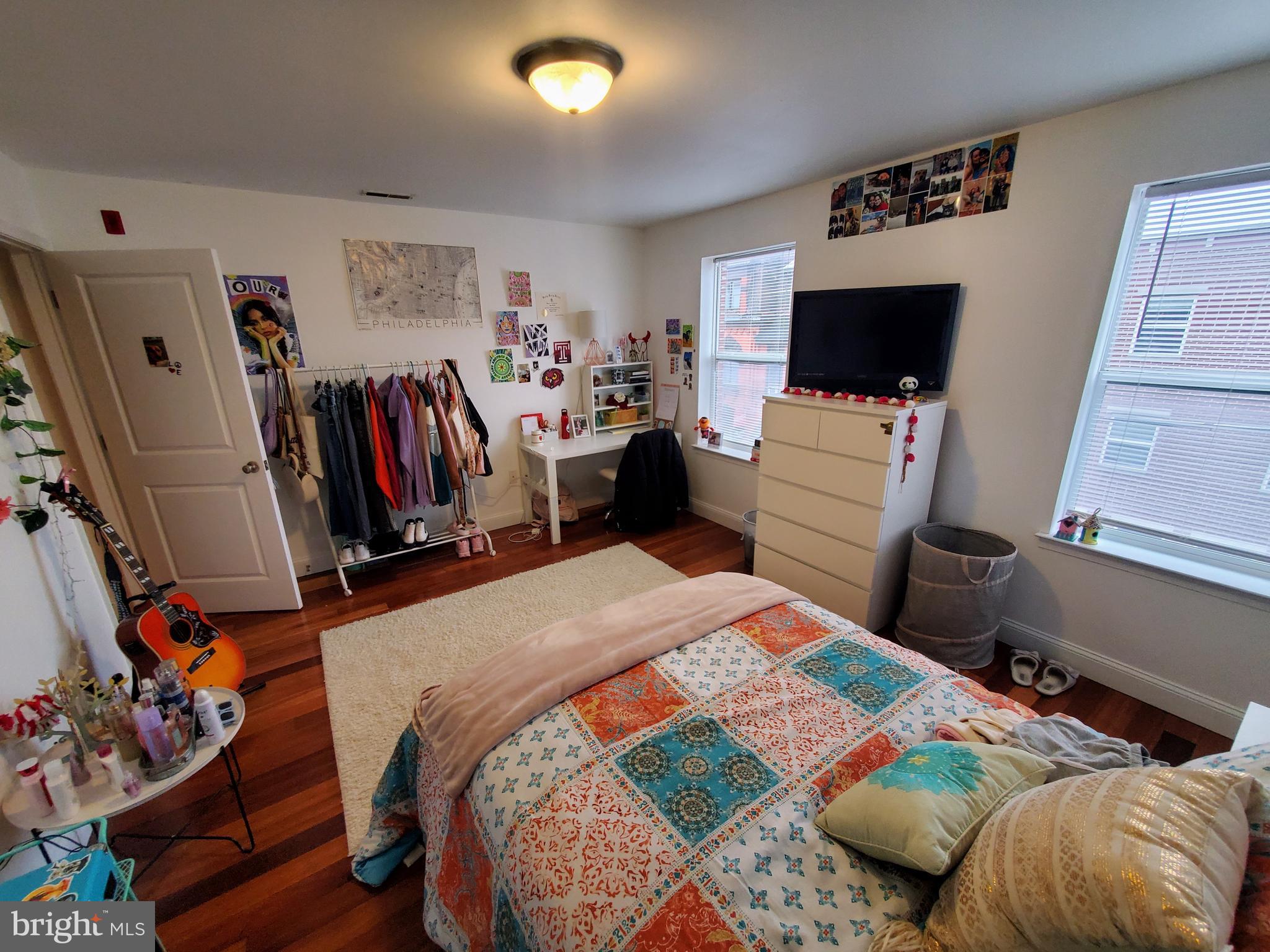 1525 North 17th Street, Unit 3 Philadelphia, PA 19121 - Photo 8 of 10 a bedroom with a bed and a flat screen tv