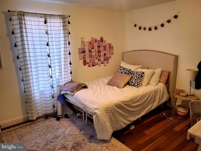 a bed sitting in a bedroom next to a wall