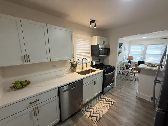 a kitchen with a sink appliances and cabinets