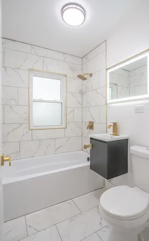 a bathroom with a toilet and a bathtub