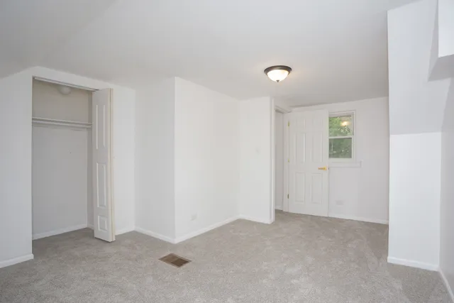 a view of an empty room with a closet