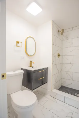 a bathroom with a toilet a sink and shower