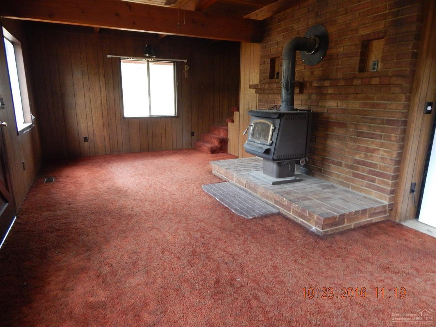 147117 Gracies Road Gilchrist, OR 97737 - Photo 9 of 22 Beautiful brick wall behind wood stove.
