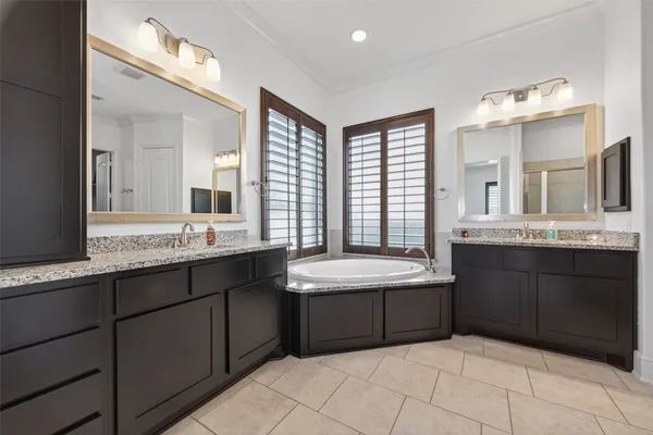 a bathroom with a granite countertop sink a toilet and bathtub