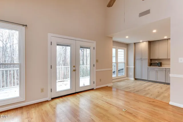 a view of a kitchen with a sink and wooden floor