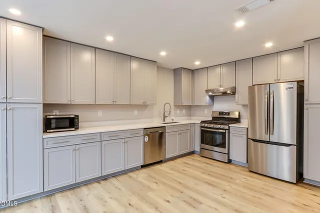 a view of a kitchen with a sink and a window