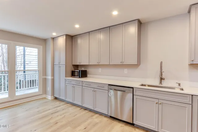 a kitchen with stainless steel appliances granite countertop a refrigerator sink and stove