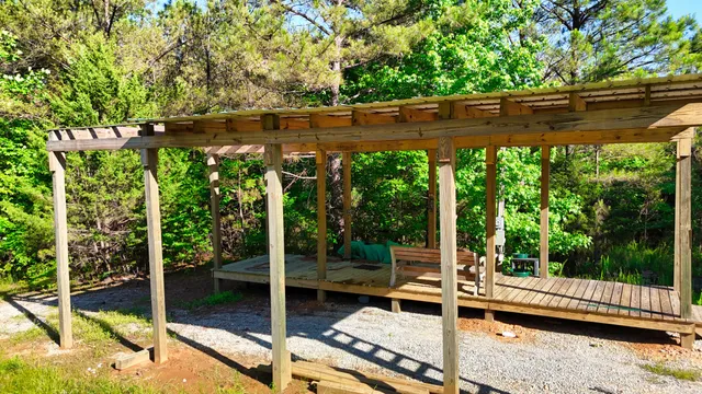 a view of a patio with table and chairs next to a yard