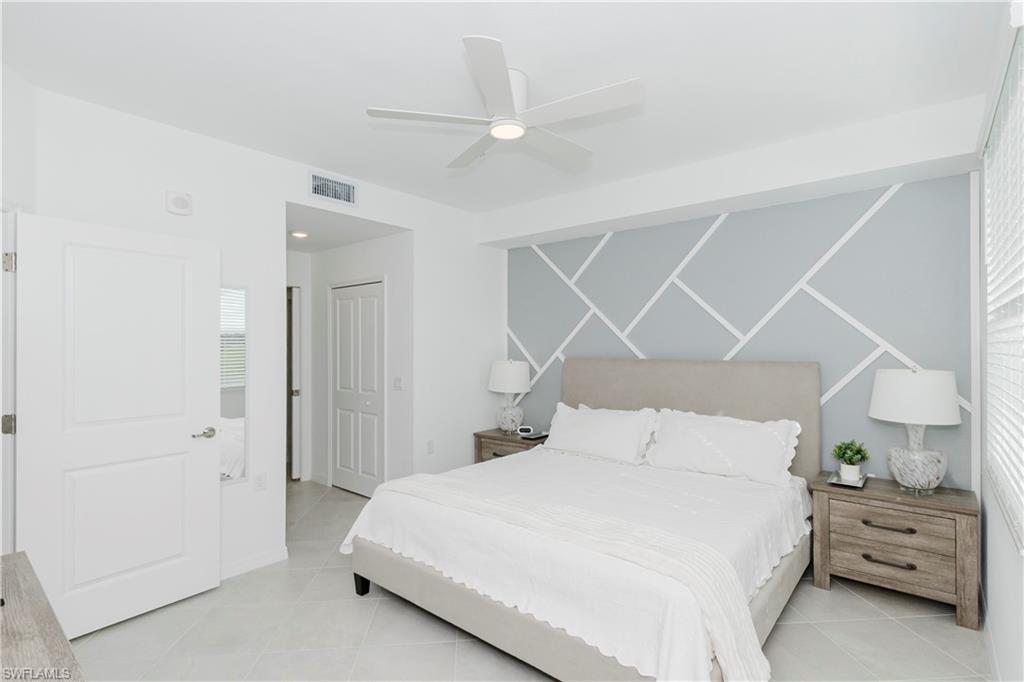 15285 Grn Acrs Avenue, Unit 418 Babcock Ranch, FL 33982 - Photo 13 of 49 a bedroom with a bed and a cabinets