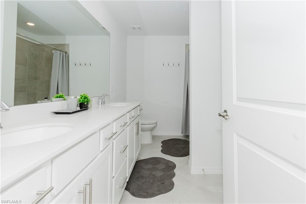 15285 Grn Acrs Avenue, Unit 418 Babcock Ranch, FL 33982 - Photo 22 of 49 a bathroom with a sink and a mirror