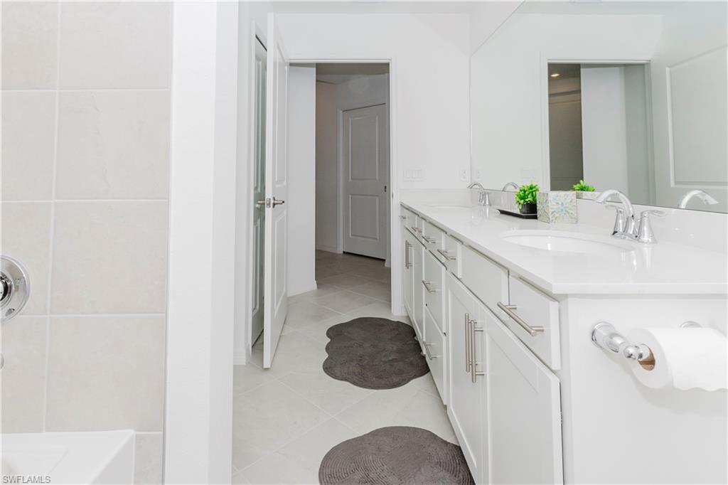 15285 Grn Acrs Avenue, Unit 418 Babcock Ranch, FL 33982 - Photo 23 of 49 a bathroom with a sink and mirror