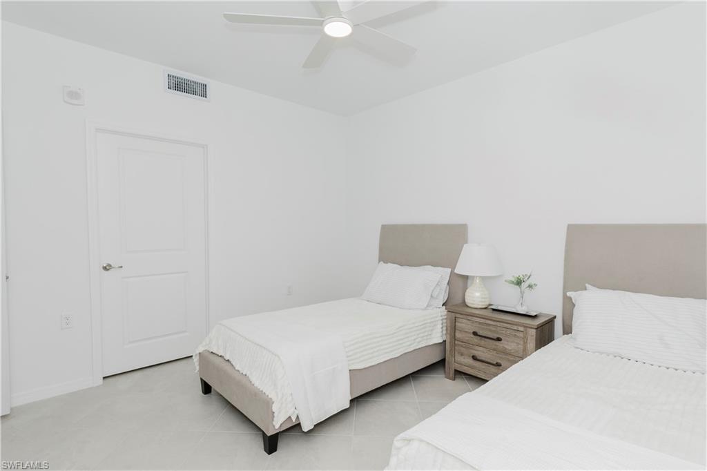 15285 Grn Acrs Avenue, Unit 418 Babcock Ranch, FL 33982 - Photo 26 of 49 a bedroom with a bed and a lamp